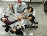happy-team-stacking-hands-on-a-creative-ideas-chart.jpg